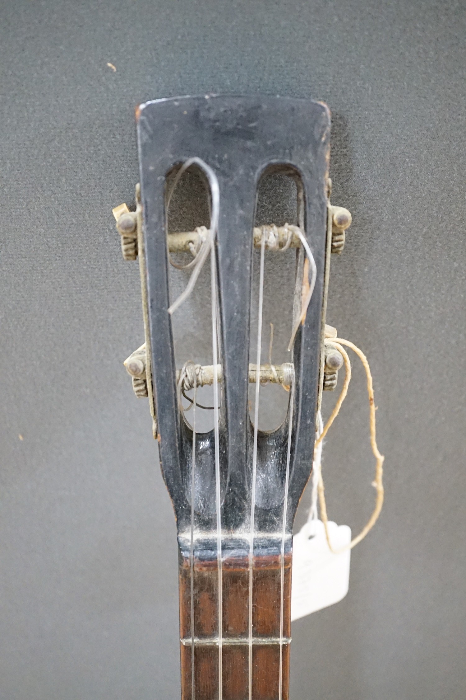 A four string banjo style parlour guitar